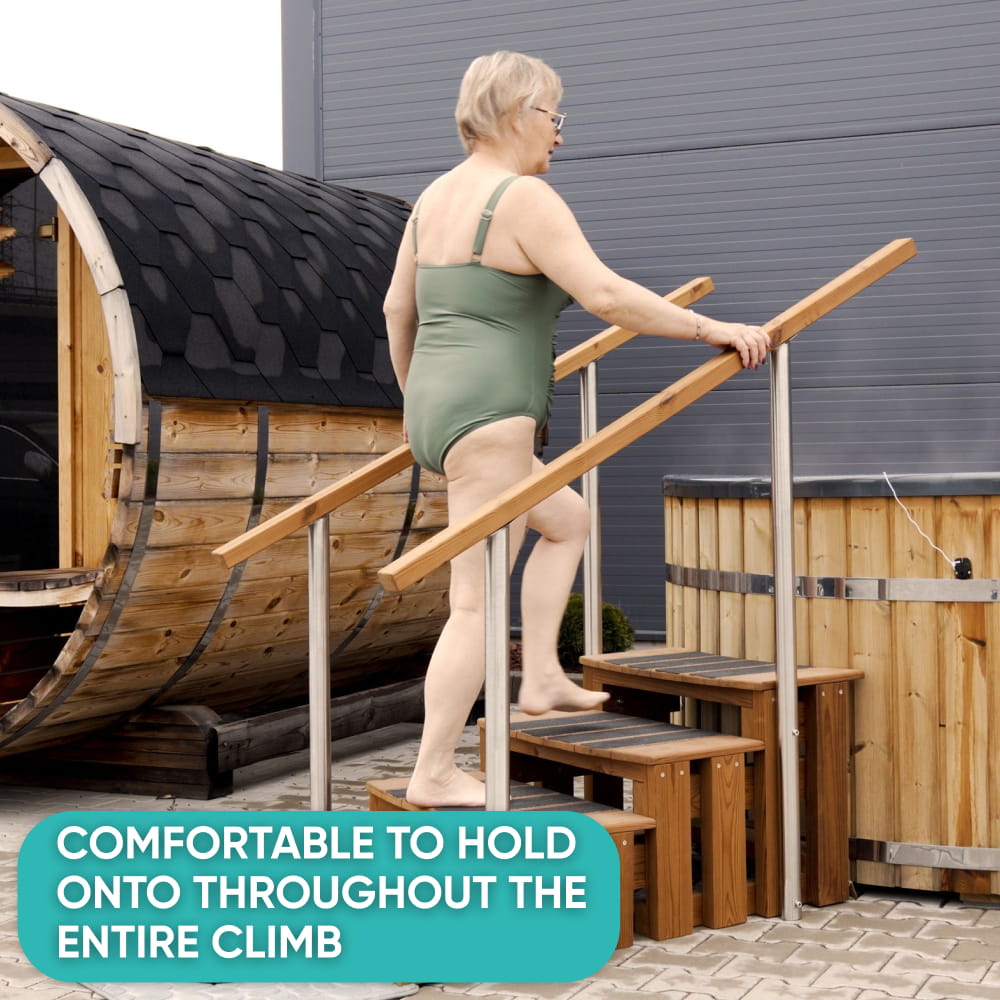 Woman climbing Premium hot tub steps into a barrel-shaped hot tub, holding the handrail throughout